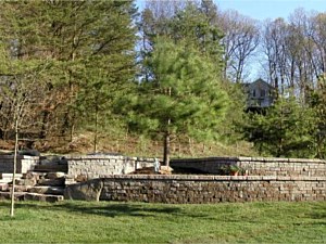 Terraced retaining walls with landscaping and natural boulder steps